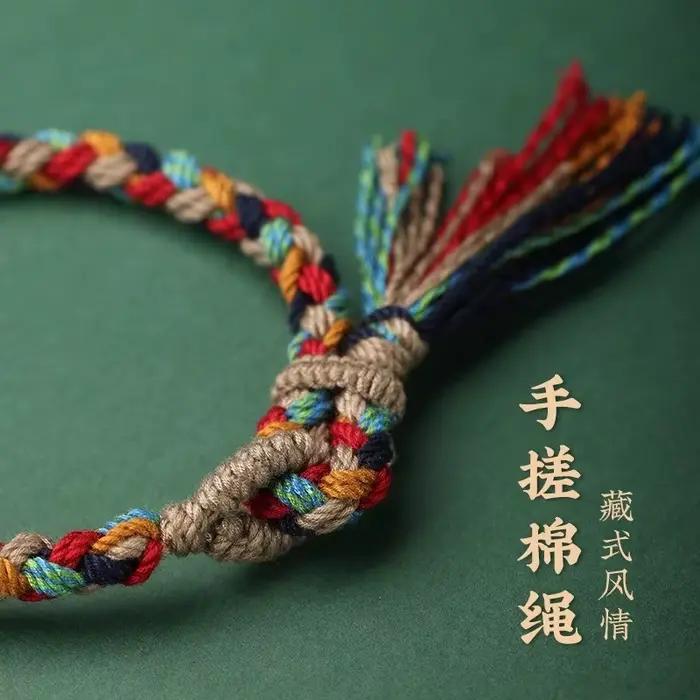 Bracelet en corde de coton tressée tibétaine fait main avec pompon – Bijou ethnique bohème pour la foi spirituelle