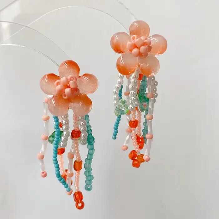 Boucles d'oreilles longues élégantes en forme de fleur, faites à la main, avec perles, design floral