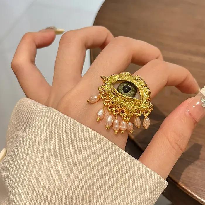 Boucles d'oreilles avec pompon en biscuits perlé pour femmes, yeux exagérés, personnalité unique, bi