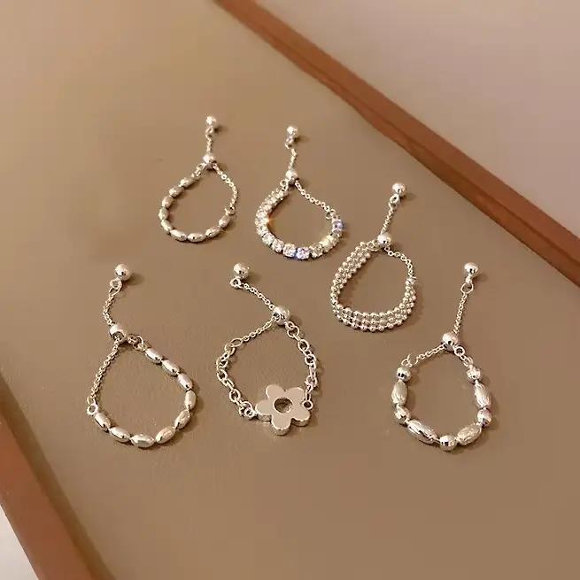 PONYKISS – bague en forme de fleur couleur argent avec longue chaîne à pampilles