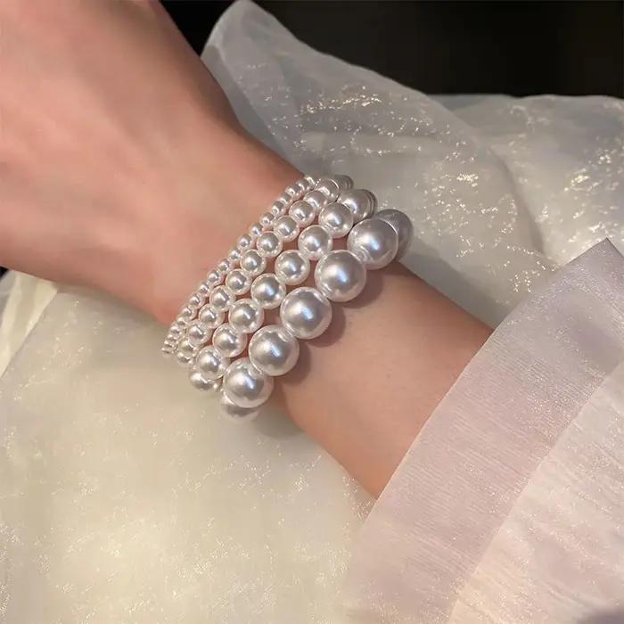 Bracelet classique élégant en perles blanches élastiques pour femmes et hommes