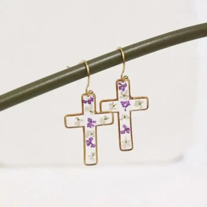 Boucles d'oreilles en résine époxy avec fleurs pressées de la série The Cross