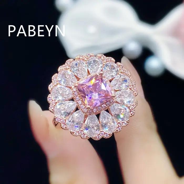 Bague en argent sterling 925 plaqué or rose avec zircon, centre rose éclatant, halo taille poire, bordure pavée festonnée, bijou glamour et luxueux
