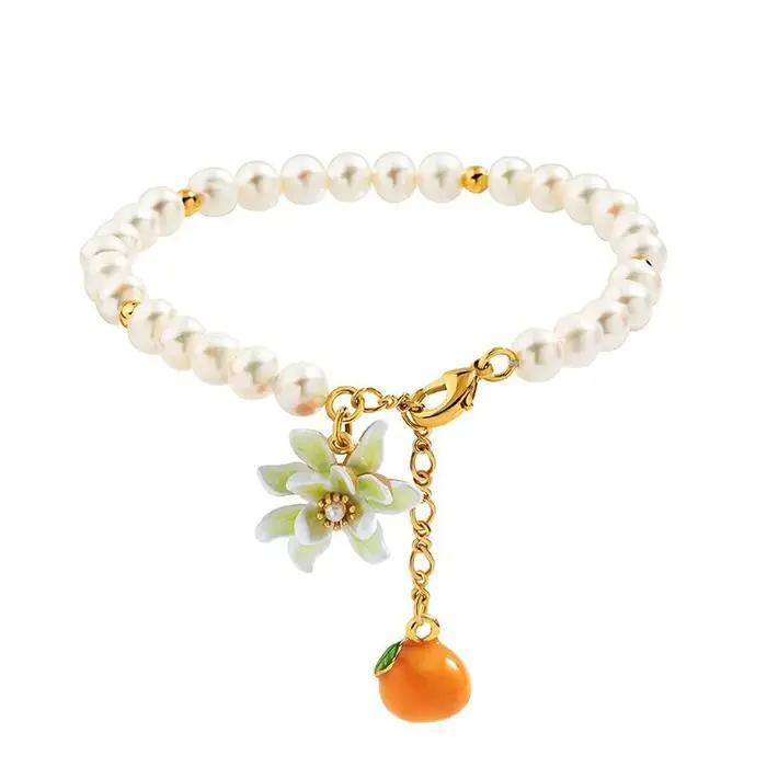 Bracelet en acrylique et cuivre style fleur orange douce pour femme occassions estivales fraicheur douceur naturelle style élégant