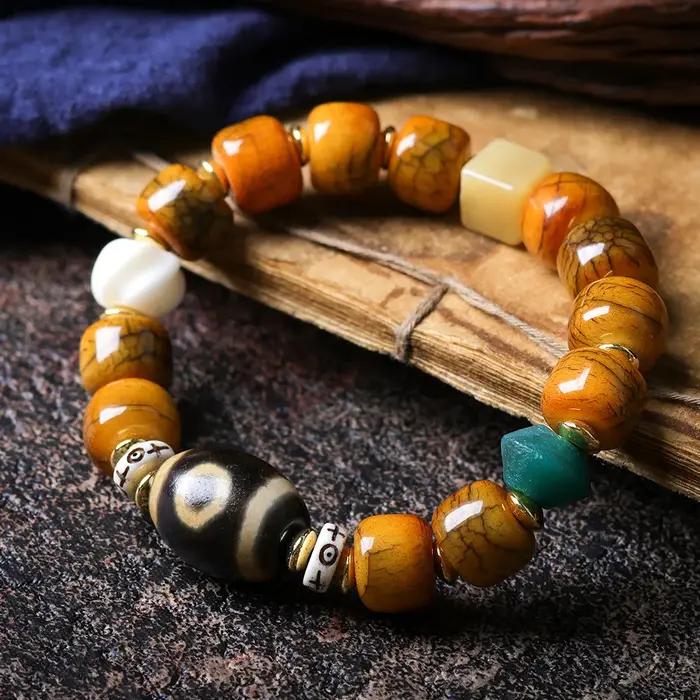 Bracelet ethnique en perles de baril craquelées en os de yak tibétain avec perle Dzi et perle en cor